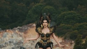 A powerful sorceress with striking makeup and an ornate feathered headdress performs a magical ritual. With outstretched arms and intense expression, she channels energy, set against a blurred - Powered by Shutterstock - Get 15% off with code: PIKWIZARD15