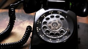 Vintage Communication: Close-Up of Man Dialing an Old Rotary Phone in 4K