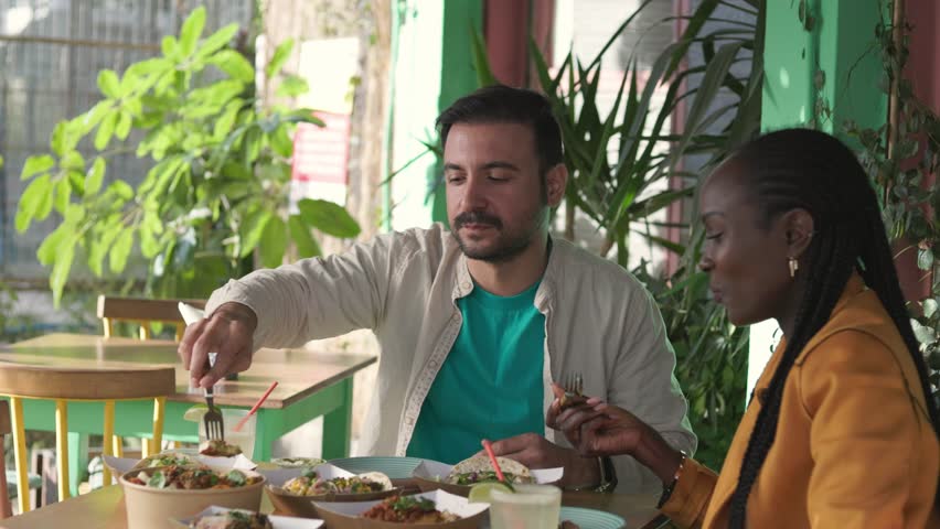 Man eating eating spicy street food at food market on summer vacations, authentic tourists experience Royalty-Free Stock Footage #1105400689