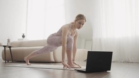 Meditation, fitness and yoga video laptop for home wellness practice with online coaching webinar. Young woman enjoying a mindfulness exercise training class with internet technology.