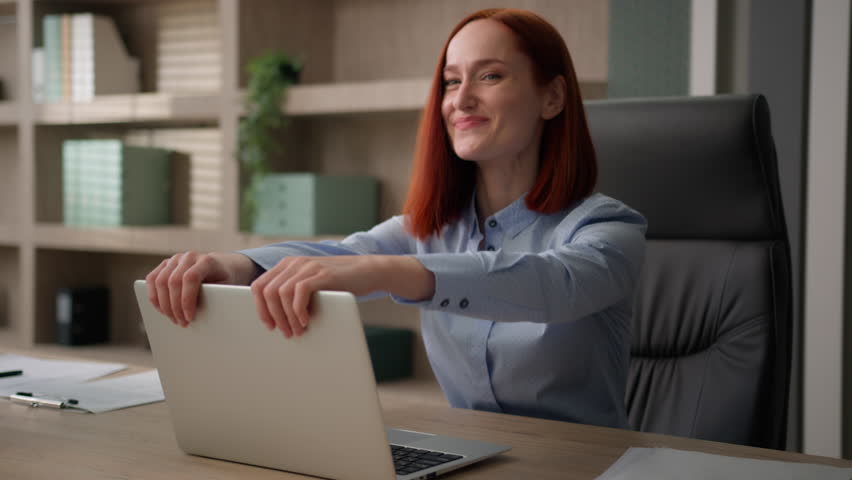 Smiling Caucasian business office worker girl woman satisfied businesswoman student finished computer work close laptop accomplish online task end job done stretching relaxing project accomplishment | Shutterstock HD Video #1105402089