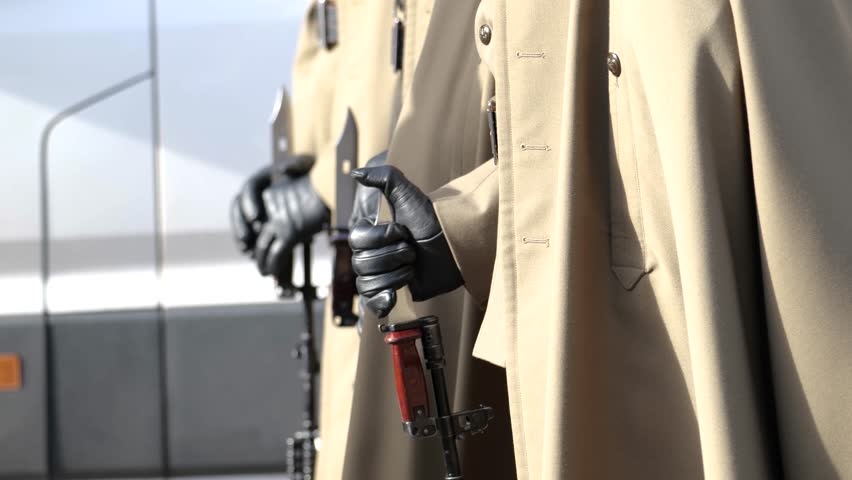 Poland, anonymous professional Polish army soldiers standing in a row, line, holding machine guns with bayonets, detail, closeup. Group of people, military representation parade, infantry concept