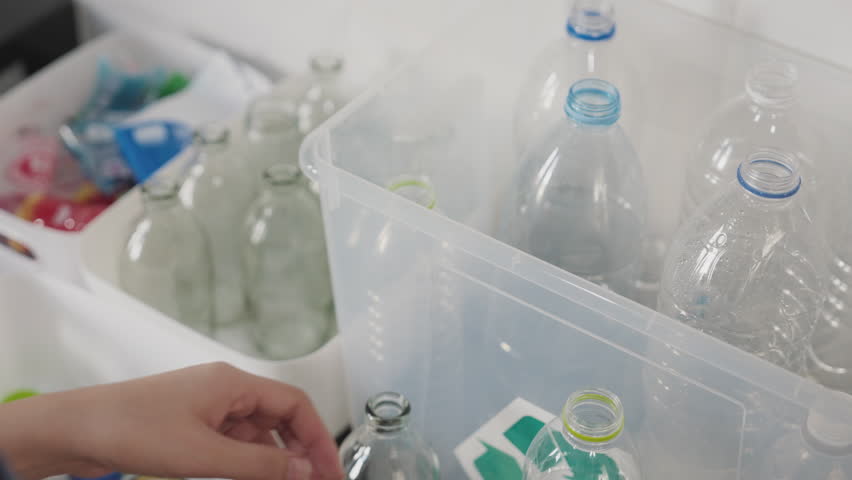 Net Zero go green eco people save the planet earth clean reuse pet single use water glass bottle lid cap sort dump to bin basket at home kitchen. Reduce CO2 social issues climate change protect action Royalty-Free Stock Footage #1105407647