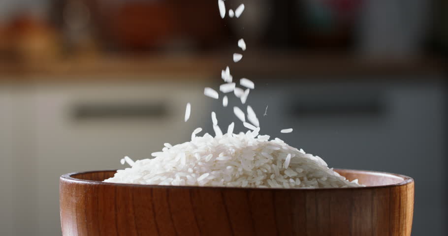 Rice being poured raw wooden cup side view home kitchen blurred background Asian Chinese Thai Japanese Indian traditional food. Sushi and rolls sashimi tasty Royalty-Free Stock Footage #1105409125