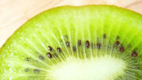 Through a macro lens, the intricate patterns of a kiwi fruit's inner flesh come to life, unveiling a mosaic of emerald-green hues interwoven with a network of slender, edible fibers. Kiwi background
