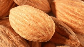 The macro lens allows for an exploration of the almond's texture and composition. The surface of the kernel may exhibit a slightly granular appearance. A almonds a sense of organic origin. 4K HDR
