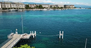 The video shows drone footage of Geneva city of Switzerland. It also shows the  beach area and port. It also shows the coastal area of Geneva and the architecture of Geneva. 