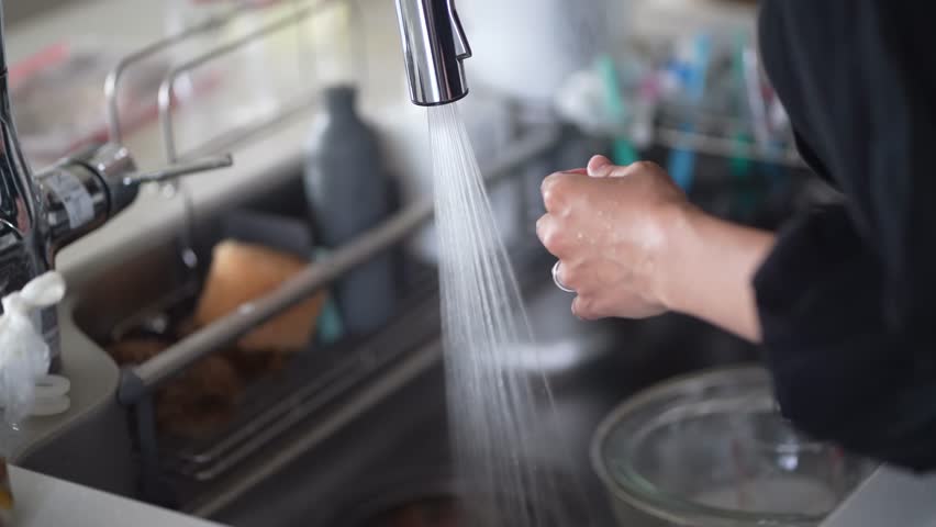 Image of a woman washing cooking utensils
 | Shutterstock HD Video #1105412947