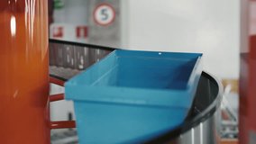 Empty Parcels Moving Forward on a Conveyor Belt System. Blue Vacant Plastic Boxes Progressing Along the Roller Conveyor. Depiction of Packaging Service and the Idea of Efficient Parcel Transportation - Powered by Shutterstock - Get 15% off with code: PIKWIZARD15