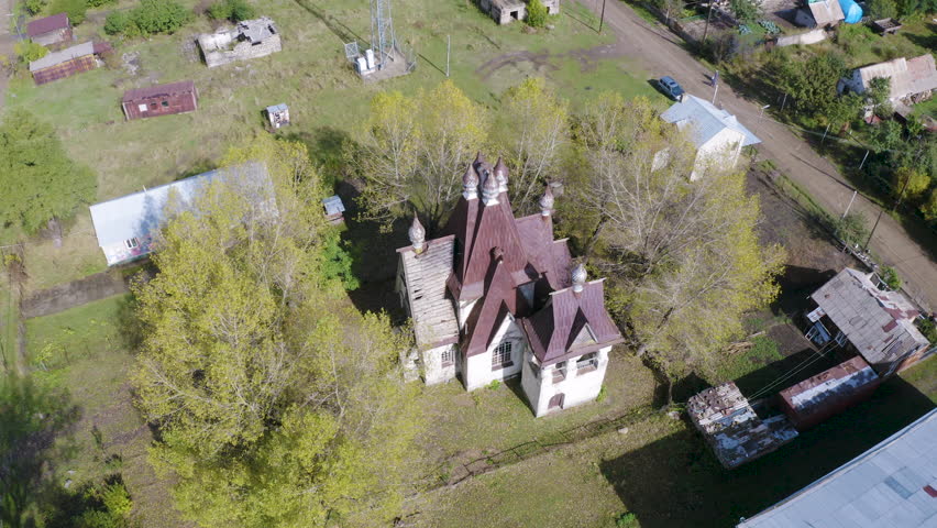 Tilt up aerial shot of orthodox St. Nicholas church on sunny autumn day. Amrakits village, Lori Province, Armenia.