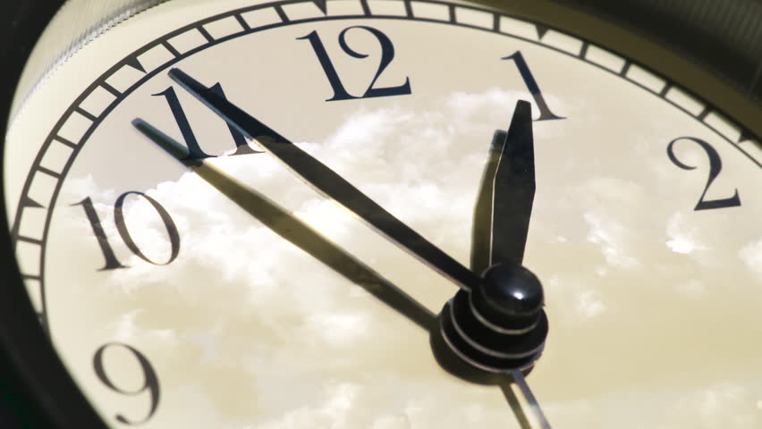 Contemplating the Flow of Time. Time laps. On the light dial of the watch, the hands rotate quickly and the sky with beautiful seething clouds is reflected