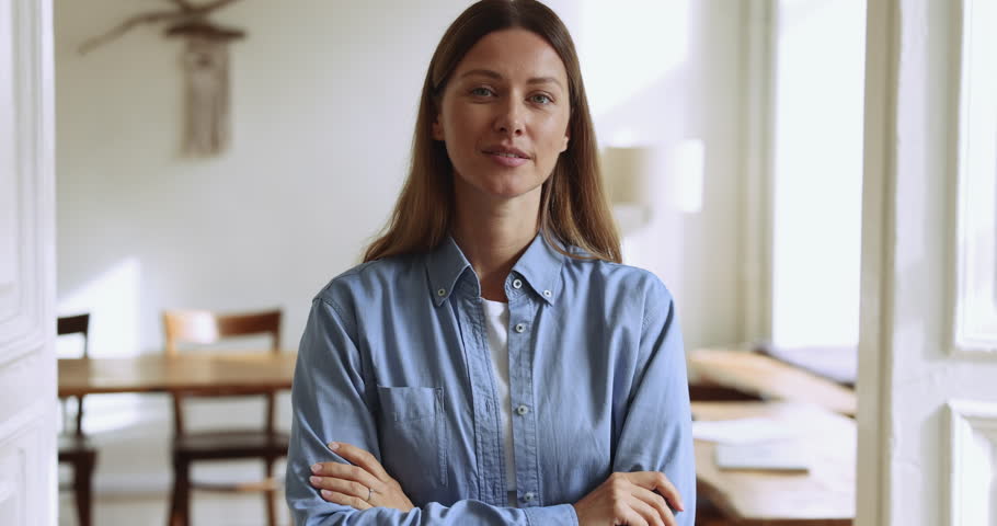 Attractive confident businesswoman or professional teacher in casual shirt smile look at camera pose with arms crossed in office, feel satisfied with career and position in company, head shot portrait Royalty-Free Stock Footage #1105424335