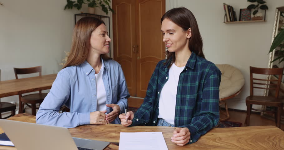 Sales manager convincing customer to buy services, happy client signing contract feel satisfied, shake hands female company representative express respect for cooperation. Successful commercial deal Royalty-Free Stock Footage #1105424361