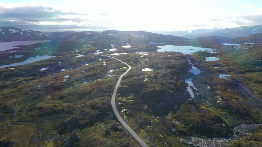 Car driving on mountain road seen from drone's aerial view in Norway | Shutterstock HD Video #1105426837