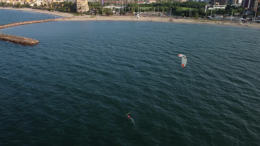 Aerial view of a person practicing kitsurfing on a beach in the city of Lecheria, northern Anzoátegui state, Venezuela