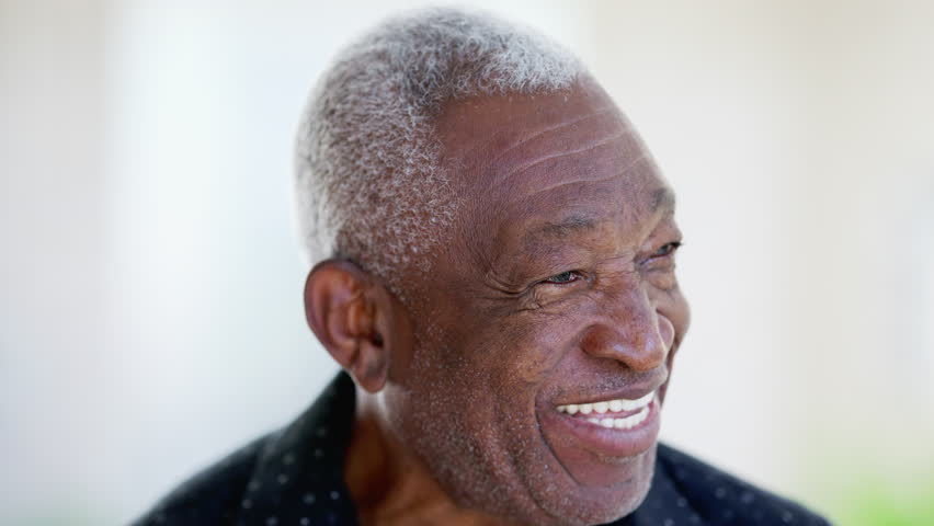 One happy friendly black senior man close-up face laughing and smiling. Portrait of a joyful African American male person in 70s Royalty-Free Stock Footage #1105427879