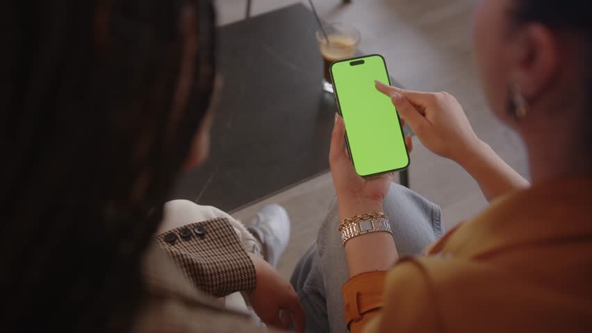 Women using smartphone with green background, scrolling on mobile phone green screen, close-up on hands - Powered by Shutterstock - Get 15% off with code: PIKWIZARD15