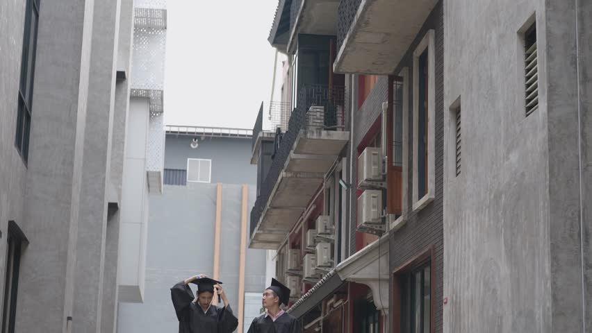 happy graduate teen people jumping with the graduation gowns in the congratulation ceremony. group of people student graduation during commencement success graduates of the university.