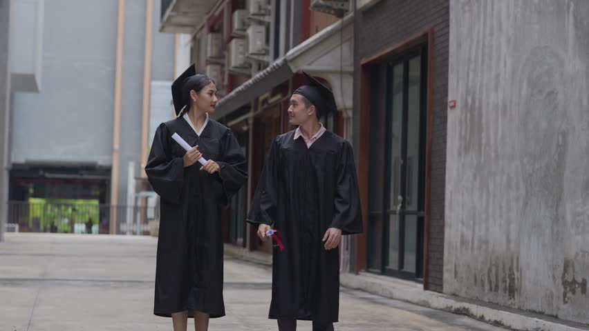 happy graduate teen people jumping with the graduation gowns in the congratulation ceremony. group of people student graduation during commencement success graduates of the university.