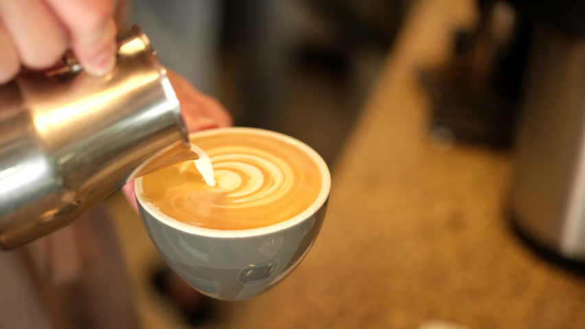 Barista making cappuccino. Barista pouring milk in cap and doing cappuccino | Shutterstock HD Video #1105443743