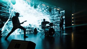 Jib shot of a drummer performing his solo during rock band concert on stage of a large venue, surrounded by bright flashing stage lights - Powered by Shutterstock - Get 15% off with code: PIKWIZARD15
