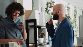 Colleagues relaxing on coffee break, having conversation and enjoying laugh together. Two business partners talking to each other before starting to work on startup development. - Powered by Shutterstock - Get 15% off with code: PIKWIZARD15