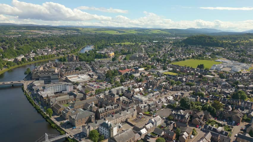 Aerial drone video of the town center of Inverness in western Scotland. The river Ness runs through the center and there are some churches around the river. Royalty-Free Stock Footage #1105447093