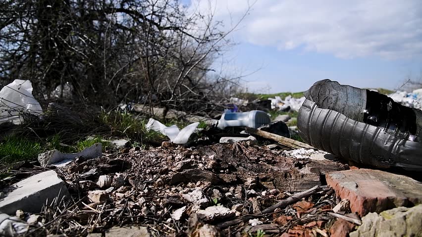 Illegal garbage dump. Household and construction debris is lying around everywhere, polluting the environment. Illegal disposal. Royalty-Free Stock Footage #1105447685