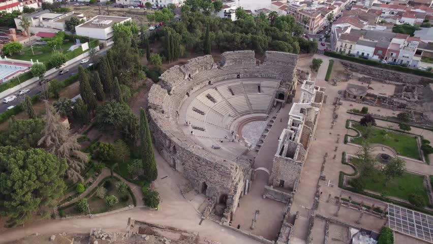 Famous roman theatre with city backdrop. Aerial wide shot. Merida, Spain