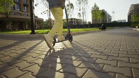 Lifestyle of a teenage girl riding a scooter in a city landscape. Sports life, cheerful children have fun and play. High quality 4k footage - Powered by Shutterstock - Get 15% off with code: PIKWIZARD15