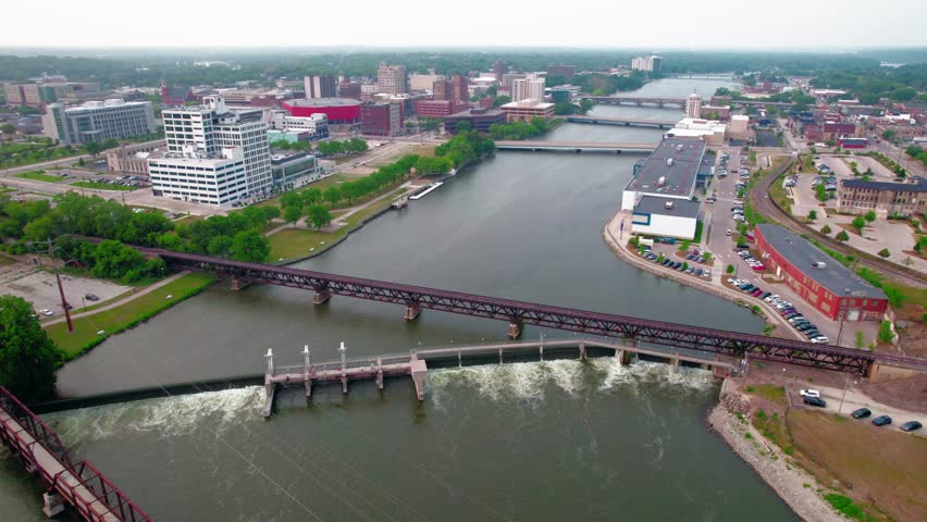 Beautiful aerial of Dam Overlook above Rock River, Morgan Street Bridge, The pedestrian bridge and many more structures from Rockford Illinois, USA. 4k Summer scenic views