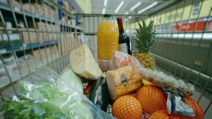 Filling the trolley with groceries in the supermarket, timelapse.