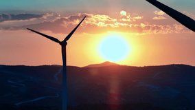 Mesmerizing Aerial Drone Video: Breathtaking Views of Wind Turbines at Sunset, Promoting Eco-friendly Energy Generation and Environmental Conservation. High quality 4k footage