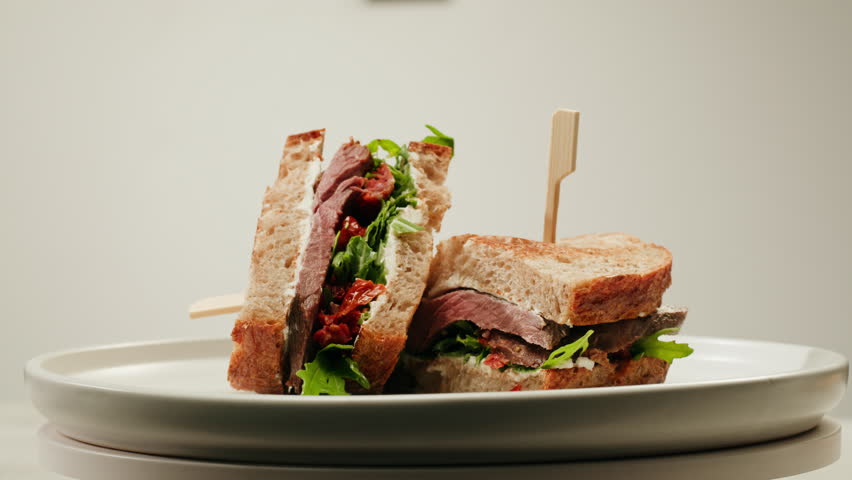 American pastrami sandwich in New York ham meet cuts. chef cooking Famous thick cut sous vide beef sandwich on restaurant cafe kitchen. Studio shot close up, macro, white background. 