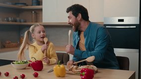 Caucasian father dad little child girl cute kid daughter happy family at home domestic kitchen singing in wooden spoons together sing song having fun fooling around playing party breakfast cooking - Powered by Shutterstock - Get 15% off with code: PIKWIZARD15
