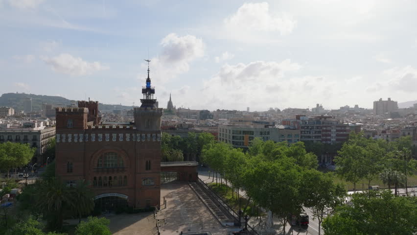 Forwards fly around historic Castell dels Tres Dragons. View of cityscape against sunshine. Barcelona, Spain