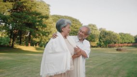 Asian senior couple give shawl and embracing in public park, Take care concept - Powered by Shutterstock - Get 15% off with code: PIKWIZARD15
