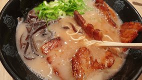 Chopsticks Eating Japanese tonkotsu ramen thick creamy pork bone broth ramen with chashu Tokyo street noodle - Powered by Shutterstock - Get 15% off with code: PIKWIZARD15