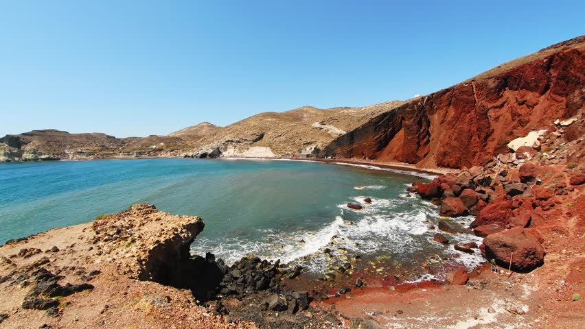 Red beach in Santorini island, Greece. Red volcanic cliffs and the blue sea, black sand on the beach. Beautiful summer landscape
