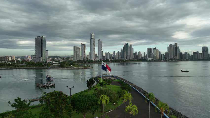 An aerial of the flag of Panama with the buildings of the capital city in the background Royalty-Free Stock Footage #1105485599