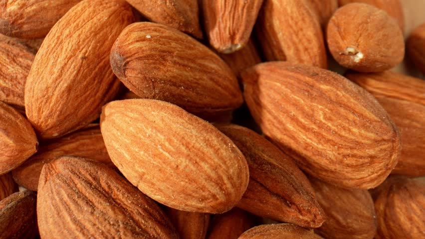 Macro video showcases almond kernels: Exquisite details of smooth texture, golden hue, and intricate patterns, capturing nature