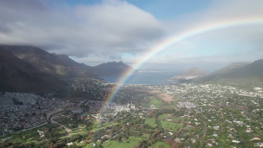 Rainbow at Hout Bay, Cape Town. South Africa landscape in the winter. Rainy and cloudy day at Cape Town. Aerial footage in 4K, 30fps.