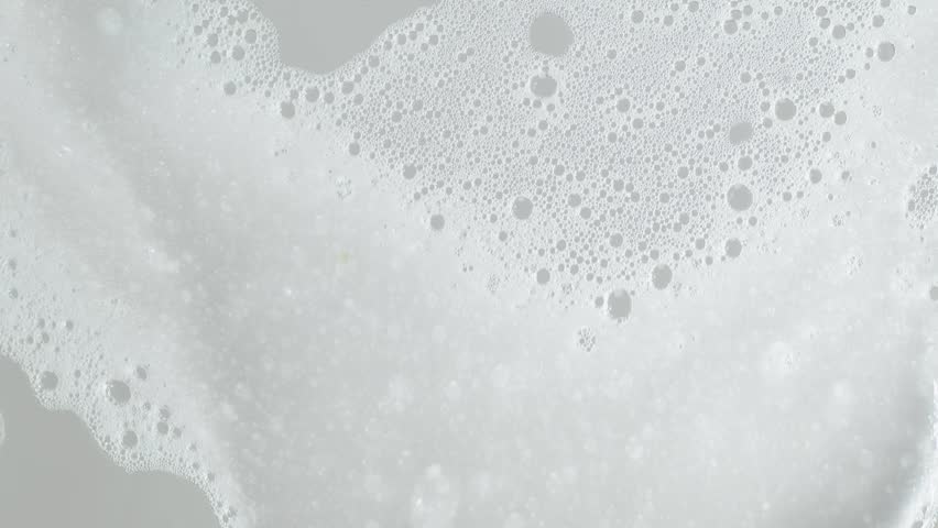 Soap foam moving in grey background, natural shampoo white bubbles motion, slow motion, 8K downscale, 4K. Royalty-Free Stock Footage #1105489805
