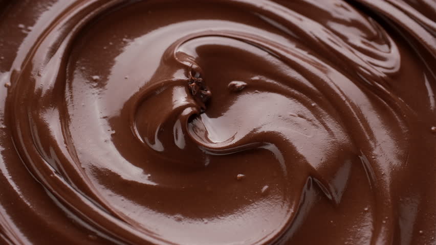 Melted liquid premium chocolate top view rotating. Confectionery concept