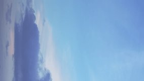 Sparse clouds glide through a vivid blue sky in a timelapse video. Vertical video. - Powered by Shutterstock - Get 15% off with code: PIKWIZARD15