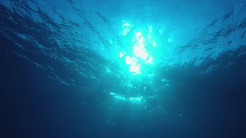 Tropical Blue Sea. Blue sea water surface. Underwater blue water air bubbles. Air bubbles blue surface. Underwater surface sea. Underwater sea water.