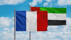 United Arab Emirates and France flag waving together in the wind on blue sky, cycle looped video, two country cooperation concept