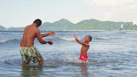 Dad playing and fooling around with his toddler son at the ocean beach having fun. Multi ethnic father playing with his young son at the beach, priceless parenthood moments.
 - Powered by Shutterstock - Get 15% off with code: PIKWIZARD15