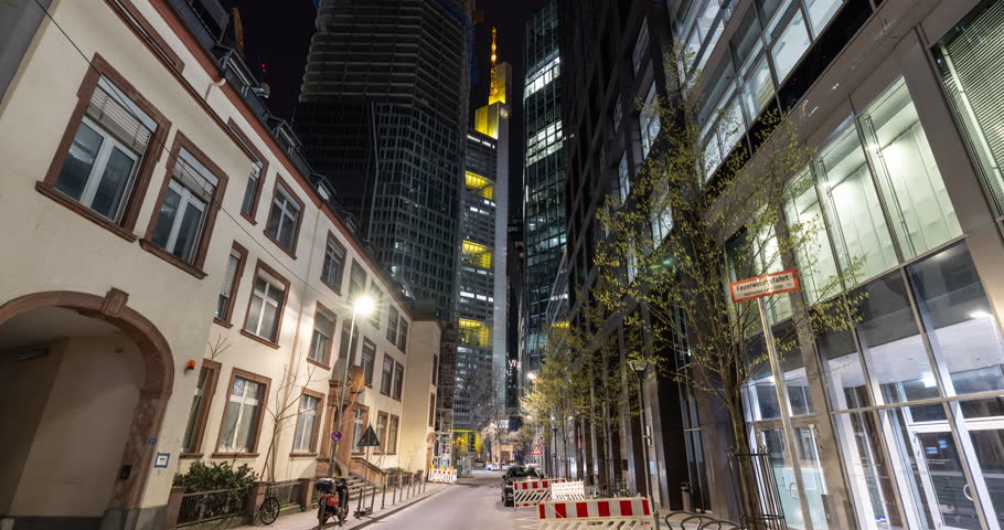 Night time walk through Frankfurt am Main, Germany. Exploring the german capital of banks, looking up modern skyscrapers.