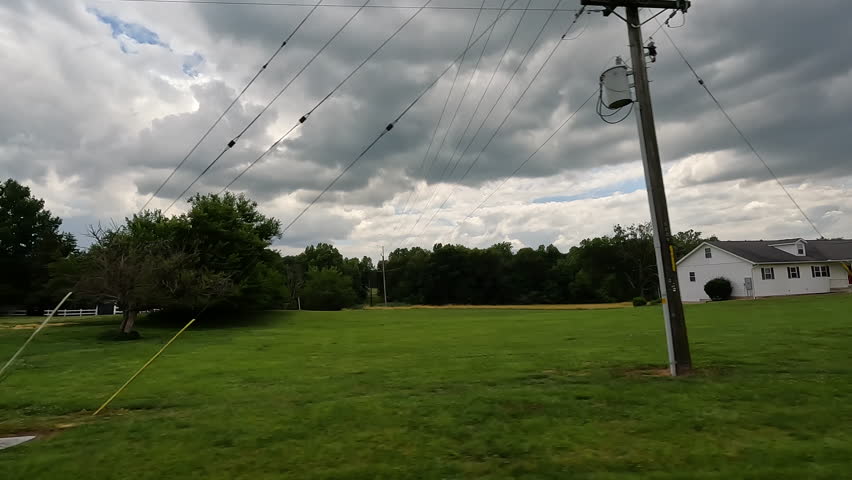 A glimpse into small town living. Traveling through rural, small town, USA with views of the simple life, big blue skies, green agricultural fields and farm land. 
